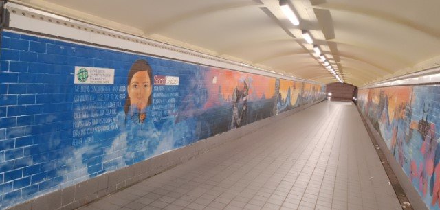 Two wall murals in the tunnel under the Coleman Bridge