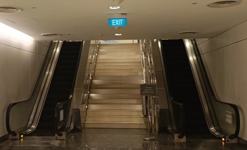 Go up the escalator.