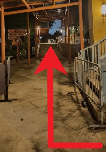 When you see the stairs on your right, turn right into the covered walkway and walk to the waterfront.