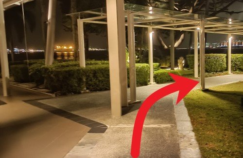 Walk from the unsheltered walkway onto the sheltered walkway and follow the sheltered walkway.